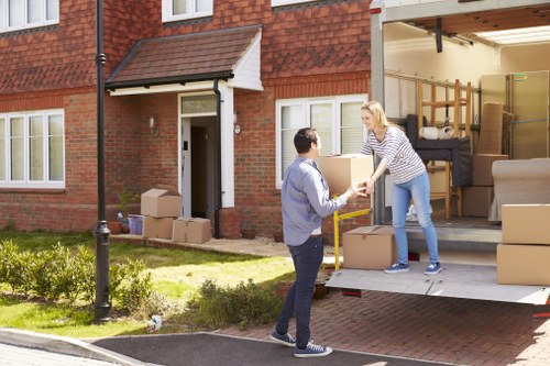 Removal team planning a flat move in Colliers Wood with boxes and furniture