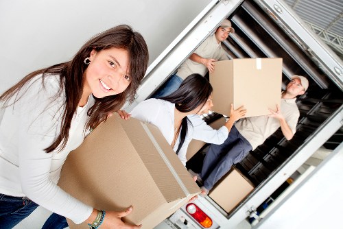 A moving team handling apartment access in Colliers Wood